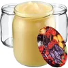 Three glass jars, one filled with a yellow substance, and a decorative lid with fruit imagery. Anteprima dell’immagine prodotto