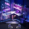 A modern gaming setup with an L-shaped desk, computer, monitor, laptop, and accessories, illuminated by neon lights. Anteprima dell’immagine prodotto