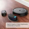 A robot vacuum cleaner and its accessories are displayed on a wooden floor. Voir les images du produit