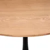 A close-up view of a round wooden tabletop with a black pedestal base. Podgląd zdjęcia produktu
