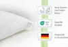 A white pillow is shown on a white surface, with three informational graphics to its right. Produktbild-Vorschau