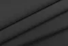 A close-up, angled view of folded black fabric, likely curtains, showing the texture and folds. Produktbild-Vorschau