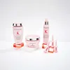 A collection of Kérastase Genesis hair care products arranged on white and coral pedestals against a white background. Náhled obrázku produktu