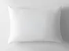 A white pillow is shown on a white and light gray background. Produktbild-Vorschau