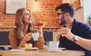 A couple enjoying coffee and cake at a cafe. Produktbild-Vorschau