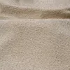 A close-up view of a textured beige fabric, likely a bed frame or upholstery. Produktbild-Vorschau