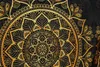 A close-up view of a golden mandala pattern on a black background. Produktbild-Vorschau