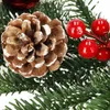 A close-up of a Christmas wreath with a pinecone and red berries. Náhled obrázku produktu