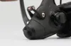 A close-up view of a black fishing reel. Podgląd zdjęcia produktu