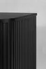 A close-up view of the fluted side of a black cabinet. Náhled obrázku produktu