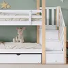 A close-up view of a white and wood bunk bed with a stuffed animal on the lower bunk. Produktbild-Vorschau