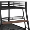 A close-up view of a black metal bunk bed with a wooden desk. Anteprima dell’immagine prodotto