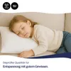 A young child sleeping on a pillow on a sofa. Produktbild-Vorschau
