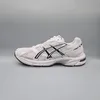 A side view of a white and black ASICS sneaker against a plain gray background. Produktbild-Vorschau