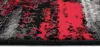A close-up view of a rug with a distressed abstract pattern in red, black, and gray. Anteprima dell’immagine prodotto