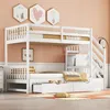 A white bunk bed with a pull-out bed and stairs, set in a room with peach-colored walls and decorative hexagonal art. Náhľad obrázku produktu