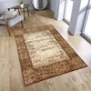 A rug is placed on a wooden floor in a room with a chair and a table. Náhled obrázku produktu