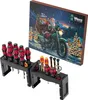 A Wera Advent Calendar 2025 Special tool set with screwdrivers and a bottle opener displayed in their holders, with the advent calendar in the background. Podgląd zdjęcia produktu