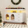 A white sideboard decorated for Christmas with a wreath, garland, and string lights. Anteprima dell’immagine prodotto