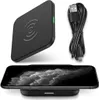 A black wireless charging pad with a USB cable and a smartphone being charged on the pad. Produktbild-Vorschau