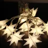 A string of white star-shaped LED lights with a battery pack in the background. Produktbild-Vorschau