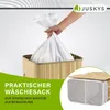 A hand is placing a white laundry bag into a bamboo laundry basket. A close-up of the laundry basket with its lid open is shown in the lower right corner. Produktbild-Vorschau