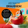 A woman in a bikini sits on a red beanbag chair outdoors, eating an ice cream. Náhľad obrázku produktu