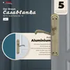 A close-up marketing image of a bronze door handle set on a dark gray background, with a circular inset showing a door with the handle installed. Text highlights features and brand. Produktbild-Vorschau