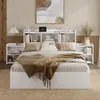A bedroom scene featuring a white bed with a bookshelf headboard and attached nightstands. Produktbild-Vorschau