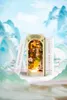 A miniature diorama of a scene with cherry blossoms, set between two books. Náhled obrázku produktu