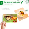 A hand holding a postcard with a butterfly on it, next to a marketing graphic of a sunflower. Produktbild-Vorschau