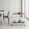 A modern kitchen or dining area with a white table and chairs, and a white serving cart. Voir les images du produit