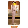 A person in pajamas holding a stuffed animal in a bedroom setting. Produktbild-Vorschau