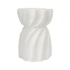 A white, speckled, twisted garden stool or side table is shown against a white background. Anteprima dell’immagine prodotto