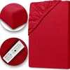 A collage of images showing a red fitted sheet, with close-ups of the fabric texture and a label. Produktbild-Vorschau