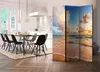 A room divider with a beach sunset scene is placed in a dining room next to a dining table and chairs. Produktbild-Vorschau