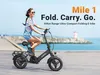 A woman riding a folding e-bike on a boardwalk by the sea. Náhľad obrázku produktu