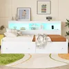 A white bed with LED lighting and storage drawers, set in a bedroom with decorative items and artwork. Produktbild-Vorschau