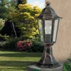 An outdoor lantern is placed on a stone surface in a garden setting. Produktbild-Vorschau