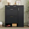 A black shoe cabinet with gold handles is shown in a room with light green paneled walls and a beige rug. Produktbild-Vorschau