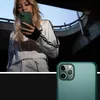 A woman holding a green phone case in an urban setting. Podgląd zdjęcia produktu