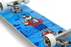 A close-up shot of a skateboard with a blue deck featuring a cartoon skeleton graphic. Produktbild-Vorschau
