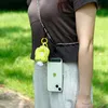 A person wearing a brown shirt and striped pants, with a phone attached to a lanyard around their neck. Produktbild-Vorschau