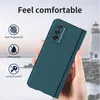 A hand holding a teal phone case with a lighthouse and ocean in the background. Produktbild-Vorschau