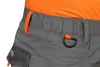 Close-up of the waistband and pocket of gray work pants, with an orange t-shirt visible at the top. Produktbild-Vorschau
