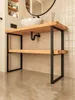 A bathroom vanity frame with a sink and plumbing. Produktbild-Vorschau