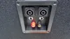 A close-up view of the input/output panel of a speaker, showing various connectors. Produktbild-Vorschau