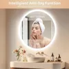 A woman is looking into a lighted mirror in a bathroom setting. Anteprima dell’immagine prodotto