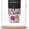 Close-up view of a water filter insert with multiple filtration layers and decorative gemstones. Produktbild-Vorschau