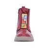 A front view of a red boot with colorful geometric shapes on the front. Produktbild-Vorschau